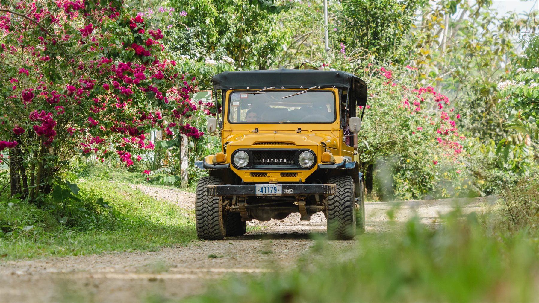 Yellow safari jeep on a mountain road