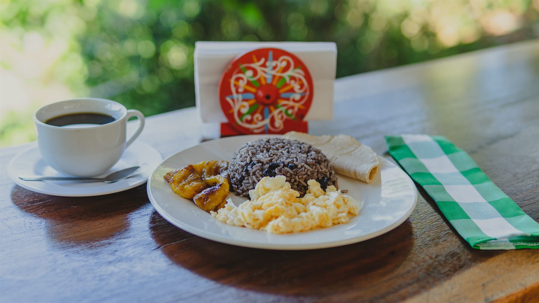 Traditional Costa Rican breakfast with gallo pinto, eggs, plantain and coffee
